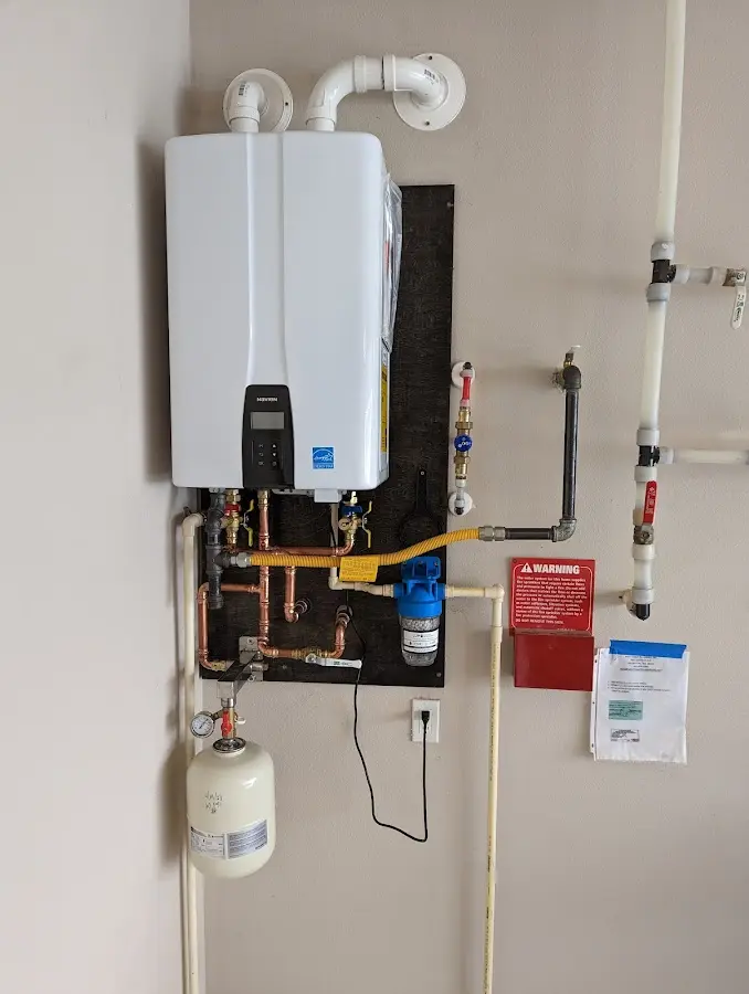 Professional plumber installing copper piping in a Dolton home